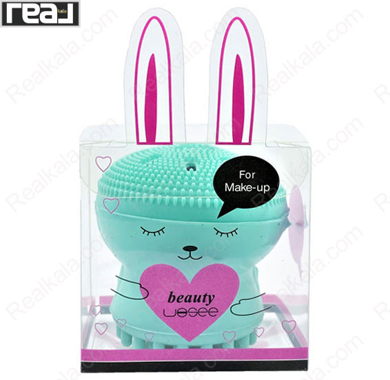 براش سیلیکونی پاکسازی صورت beauty فیروزه ای با طراحی فانتزی، دارای پرزهای سیلیکونی ریز در بخش بالایی و بسته‌بندی شفاف